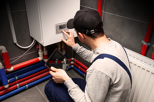 The,Technician,Checking,The,Heating,System,In,The,Boiler,Room